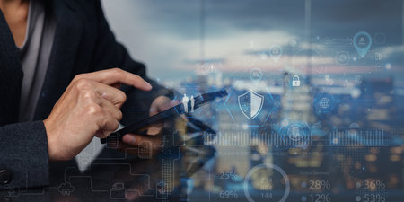 A close-up view of a person using a smartphone to interact with modern technology, illustrating the concept of Internet of Things with digital icons and data.の写真素材