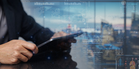 A close-up of a hand holding a tablet showcasing the Internet of Things technology, highlighting digital connectivity, innovation, and smart device integration in a modern setup.の写真素材