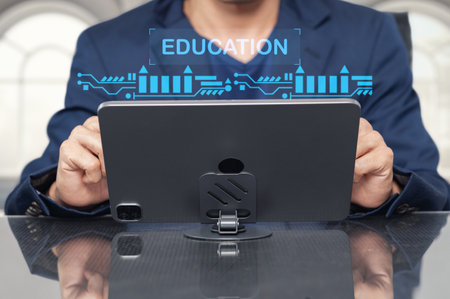 A person holds a tablet displaying an educational interface, symbolizing the integration of technology in learning. The modern workspace enhances productivity and engagement.の写真素材