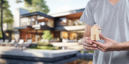 People holding house models, concept of buying, selling, renting houses, paying off houses.の写真素材
