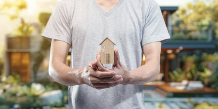 People holding house models, concept of buying, selling, renting houses, paying off houses.の写真素材