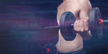 A focused individual enhancing muscle strength using dumbbells in a vibrant gym setting. Perfect for fitness and workout inspiration.の写真素材