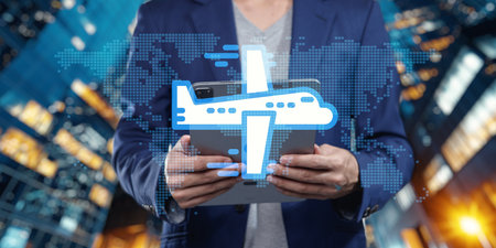 A professional man holds a tablet featuring an airplane icon, representing the essence of business travel abroad amidst an urban skyline at night.の写真素材