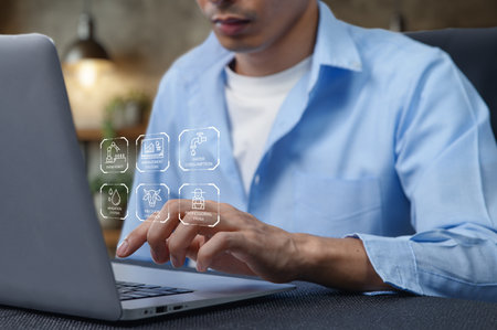 This image depicts an individual analyzing smart farm systems on a laptop, focusing on operations, efficiency, and growth potential in agriculture.の写真素材