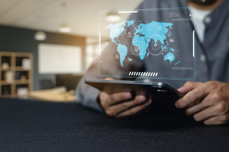 A person uses a tablet to analyze global shipping and receiving operations. Innovative strategies...