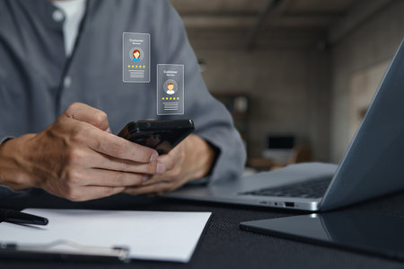 A close-up view of hands using a smartphone to display digital business cards, showcasing engagement and interaction in a modern workspace environment.の写真素材