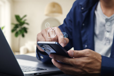 A person using a smartphone to manage logistics and transportation for goods import and export. The scene highlights modern technology's role in enhancing efficiency and organization in business operations.の写真素材