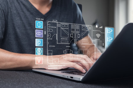 A person actively designs a modern home layout using a laptop, showcasing digital blueprints and innovative technology for interior planning and visualization.の写真素材