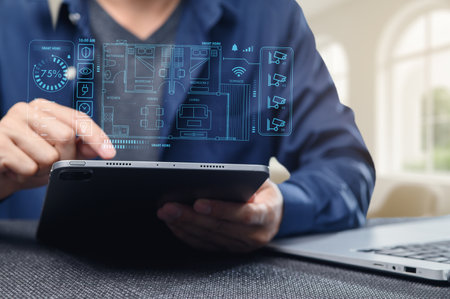 A person interacts with a tablet displaying smart home controls and automation features. The image captures technology's role in modern living and convenience.の写真素材