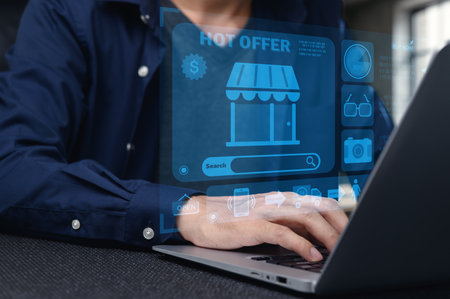 A person engaged in online shopping on a laptop, with a vibrant digital display showcasing offers and features, illustrating modern retail experiences and e-commerce.の写真素材