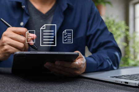 A professional engages with digital documents on a tablet, showcasing the shift towards electronic solutions in modern workplaces. This image emphasizes productivity and efficiency.の写真素材