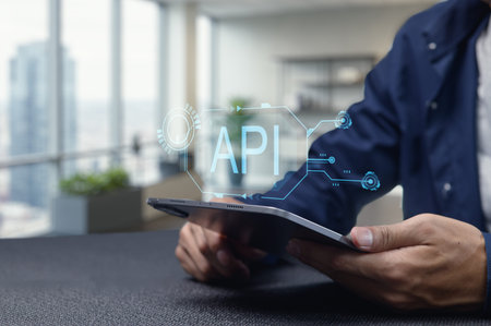 A close-up of a person using a tablet to interact with a digital API interface, showcasing modern...
