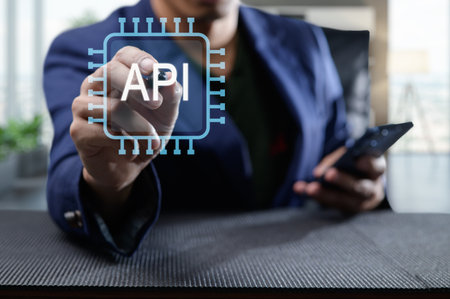 A business professional interacts with a digital representation of an API interface on a smartphone, symbolizing modern programming and integration concepts.の写真素材
