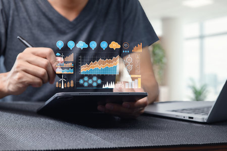 A professional workspace featuring a person using a tablet to display an innovative digital dashboard. Visualize sustainability and technology trends through data analytics and exciting graphics.の写真素材