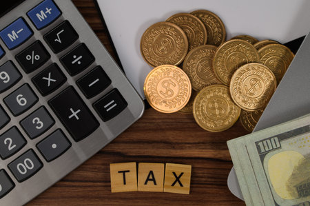 Close-up view of a calculator, coins, and cash on a wooden table showing tax-related elements, ideal...