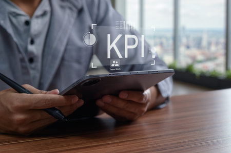 A business professional analyzes key performance indicators (KPIs) on a tablet, emphasizing the importance of data-driven decision-making and teamwork for growth.