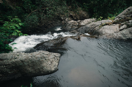 Discover a captivating view of a waterfall near Jetkot, surrounded by lush greenery. This scenic spot offers a serene experience in nature's embrace.の写真素材
