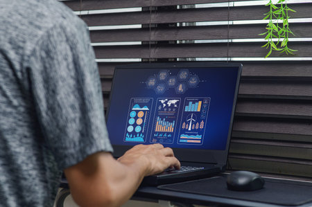 A close-up of a person interacting with a laptop, showcasing visual data representation on...