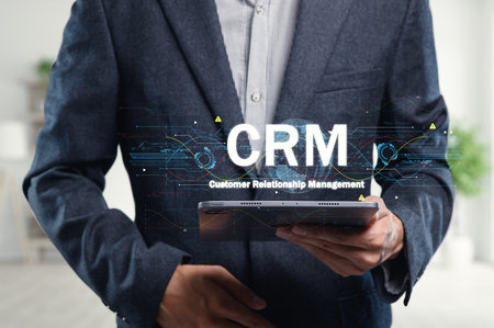 A professional man uses a tablet showcasing CRM concepts, symbolizing effective relationship management and business growth strategies in the digital age.の写真素材