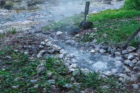 Discover the soothing hot springs in Chiang Mai, Thailand. This serene site features warm, bubbling water surrounded by lush greenery, perfect for relaxation.の写真素材