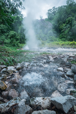 Explore the stunning hot springs of Pong Duat in Chiang Mai, where steam rises from the mineral-rich waters, creating a serene and tranquil atmosphere surrounded by lush greenery.の写真素材