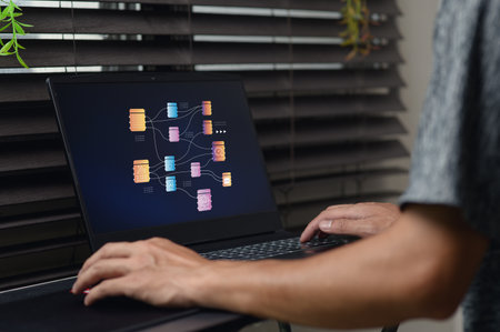 A person interacts with a modern analytic dashboard displayed on a laptop screen, showcasing vibrant data visualizations. Ideal for business and technology themes.の写真素材