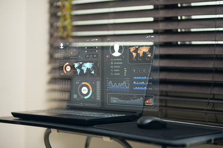 A sleek laptop displaying an advanced data dashboard with vibrant graphics and analytics. The workspace features modern design elements and a professional atmosphere.の写真素材