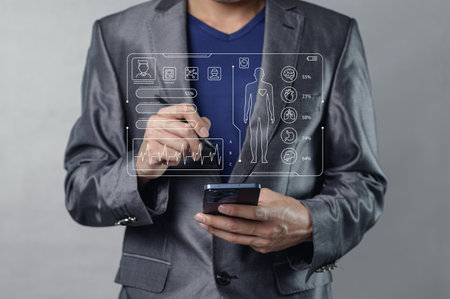 A professional man interacts with advanced health technology, using a smartphone to manage patient care, showcasing medical data and analytics.の写真素材