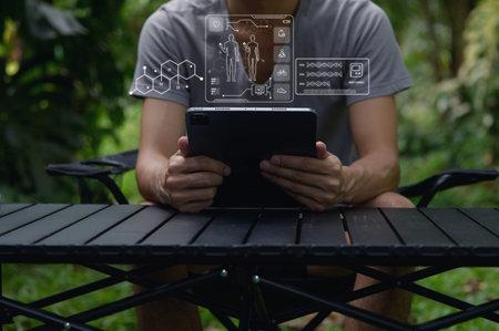 A person interacts with a tablet in a natural setting, showcasing health and care technology on the...