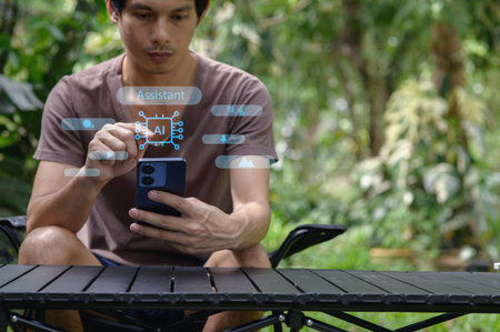A man interacts with a smartphone displaying a virtual assistant interface in a lush outdoor...