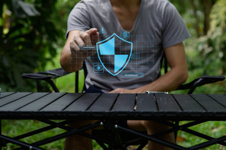 A person interacting with a digital security interface in a natural setting, showcasing the blend of technology and outdoor lifestyle, emphasizing modern networking concepts.の写真素材