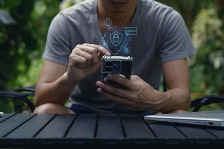 A person interacts with a smartphone outdoors, engaging with network security features displayed on the screen, highlighting modern technology use and privacy concerns.の写真素材