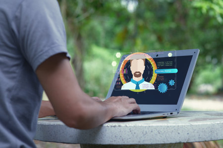 A person engages with a laptop outdoors, showcasing a modern interface for personal information management. This scene combines technology with nature, highlighting innovation.の写真素材