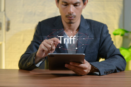 A focused man engages with a tablet in a professional setting, showcasing innovation and digital solutions. Ideal for themes of technology and business.の写真素材