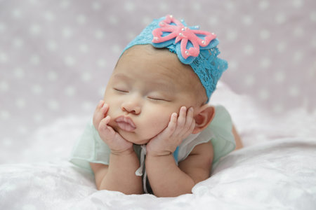 Newborn baby girl sleeping. (asian)