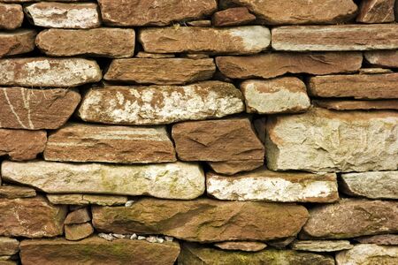 Dry stone walls are known in Scotland as dry stane dykes. These structures are built without the use of either concrete or concrete to bind the construction together. They are used in boundary walls, sheep pens and also in cottages.の写真素材
