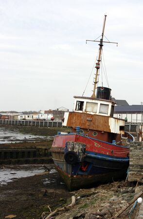 Old tug beached on the quayside of the River Irvine, Scotlandの写真素材