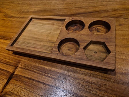 Wooden box for kitchen utensils on a wooden table.