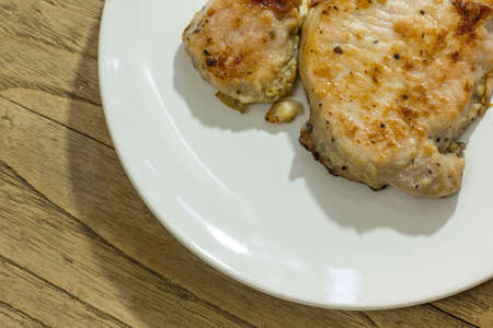 beef steak in dish on the wood backgroundの写真素材