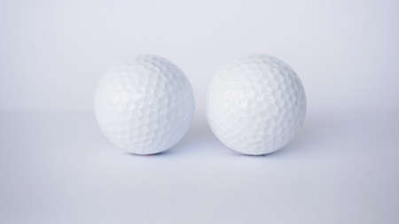 two white golf ball on the isolated backgroundの写真素材