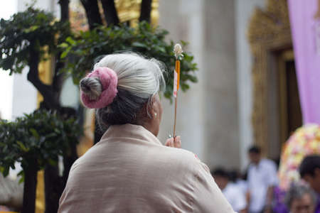 BANGKOK, THAILAND - October 3   Thai Buddhist woman donates banknote in donation tree for Charity on October 3, 2013 のeditorial素材