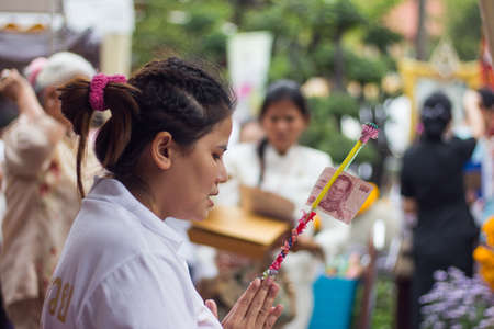 BANGKOK, THAILAND - October 3   Thai Buddhist woman donates banknote in donation tree for Charity on October 3, 2013 のeditorial素材
