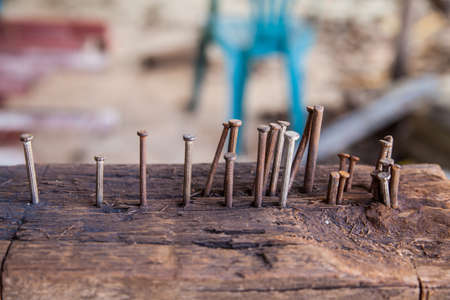 Tack in old wooden  for frizzle steel in construction siteの写真素材