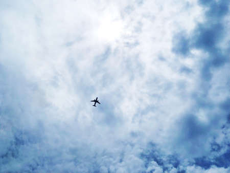 Bottom view of a plane in the sky.の素材