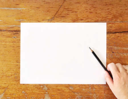 Top view of empty paper on the table with hand writing.の素材