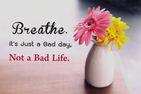 Bouquet of flowers in a vase on the table with the text Be the best version of lifeの写真素材