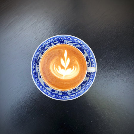 Coffee cup with latte art on wooden table background.の写真素材