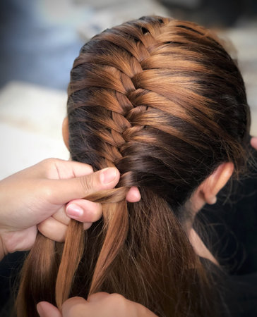 Hairstyle in hairdresser's hands, closeup