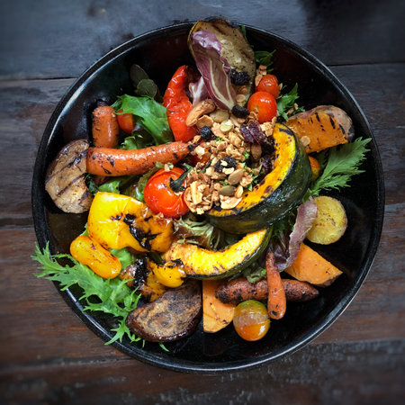 Pumpkin salad with meat and vegetables on wooden table, top viewの写真素材