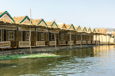 photo of bamboo lodgings beside the Man river, at Shwe Set Taw pagoda, Myanmarの写真素材